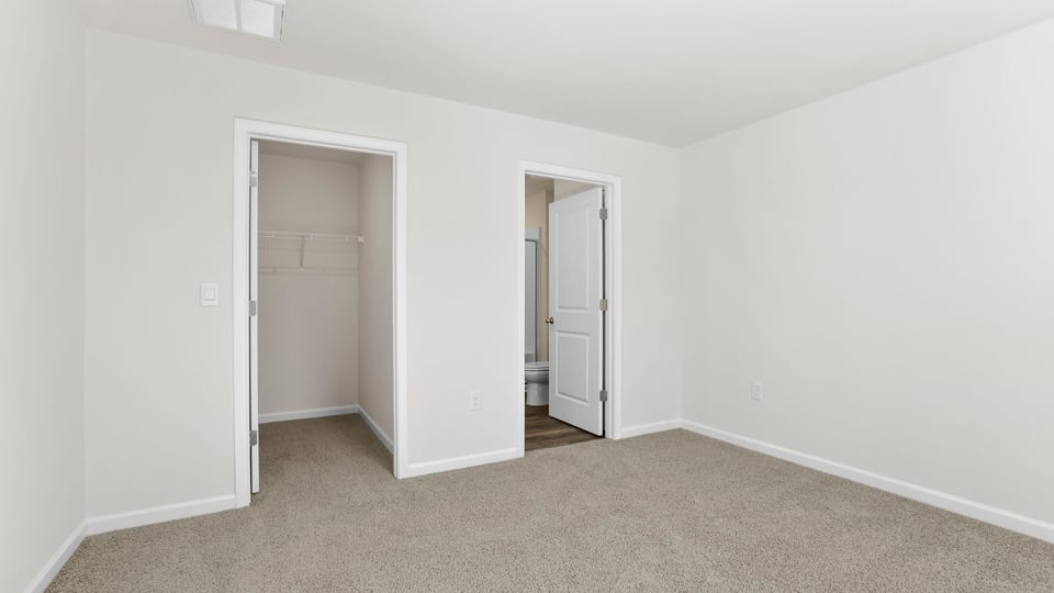 Bedroom with carpet and window.