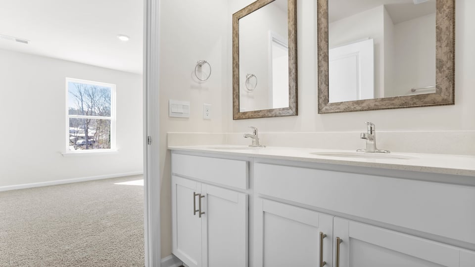 Bathroom with double vanity and walk in shower.