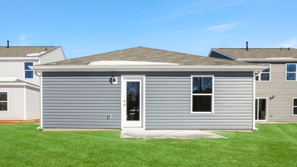 Exterior of home with large backyard.