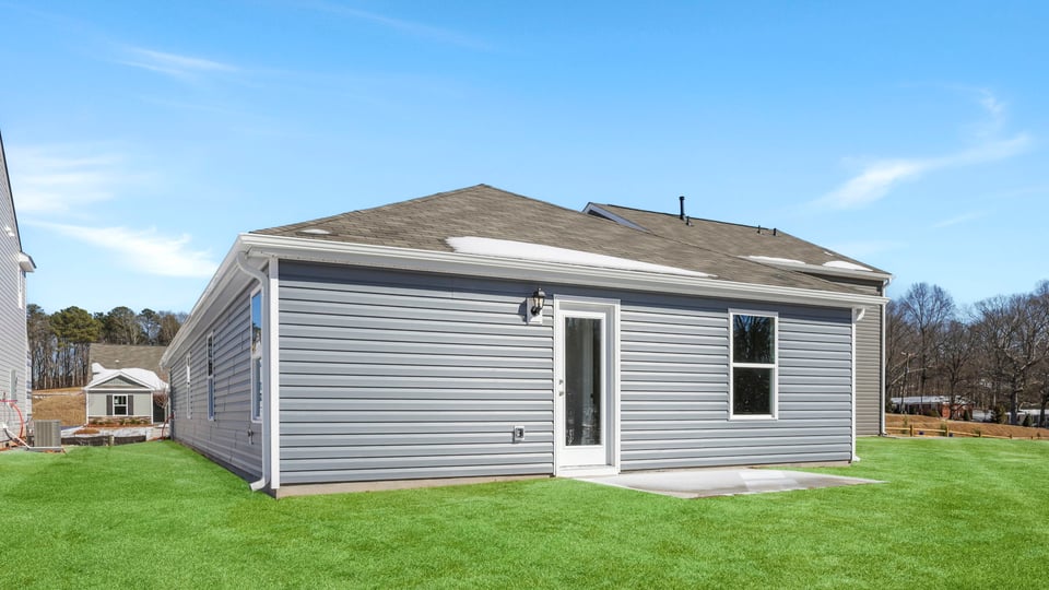 Exterior of home with large backyard.