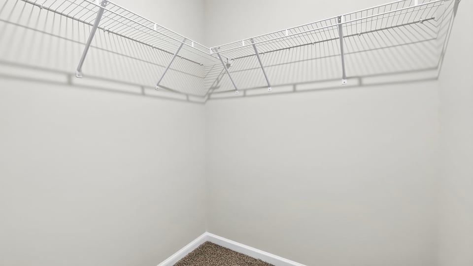 Primary closet with shelf.