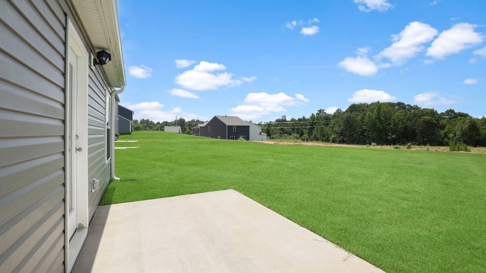 Back exterior with large backyard.