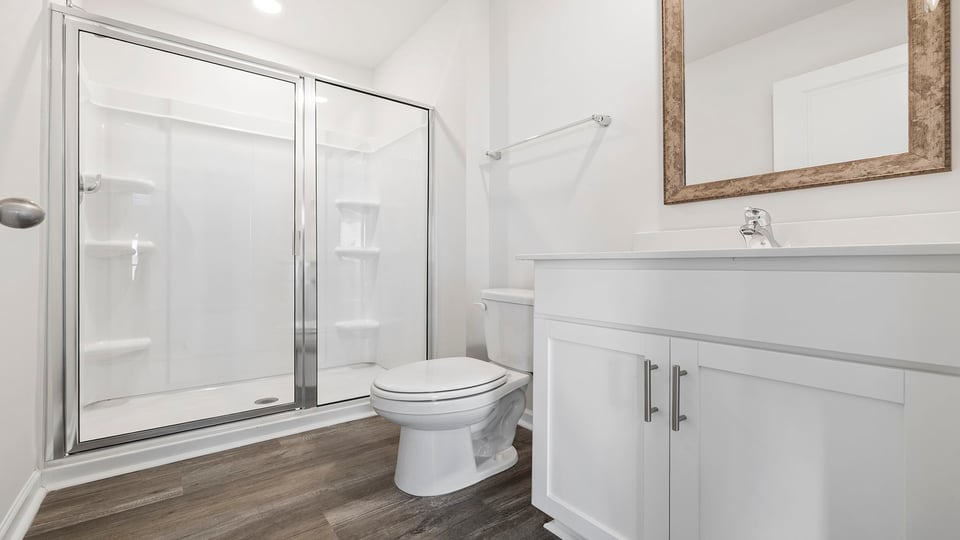 Bathroom with vanity and walk in shower.