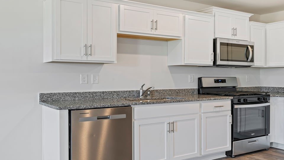 Kitchen with granite countertops and stainless steel appliances.