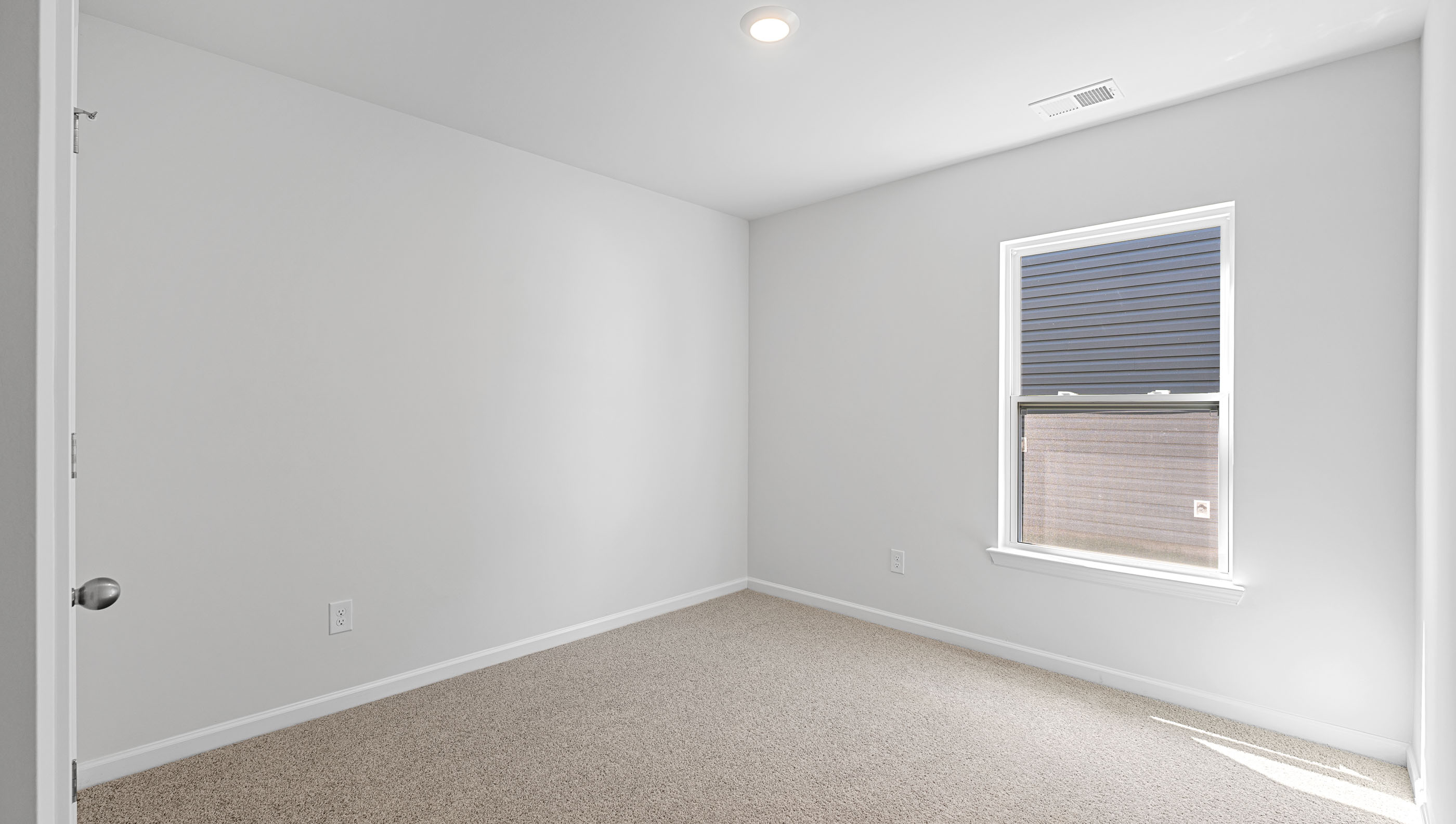 Bedroom with carpet and window.
