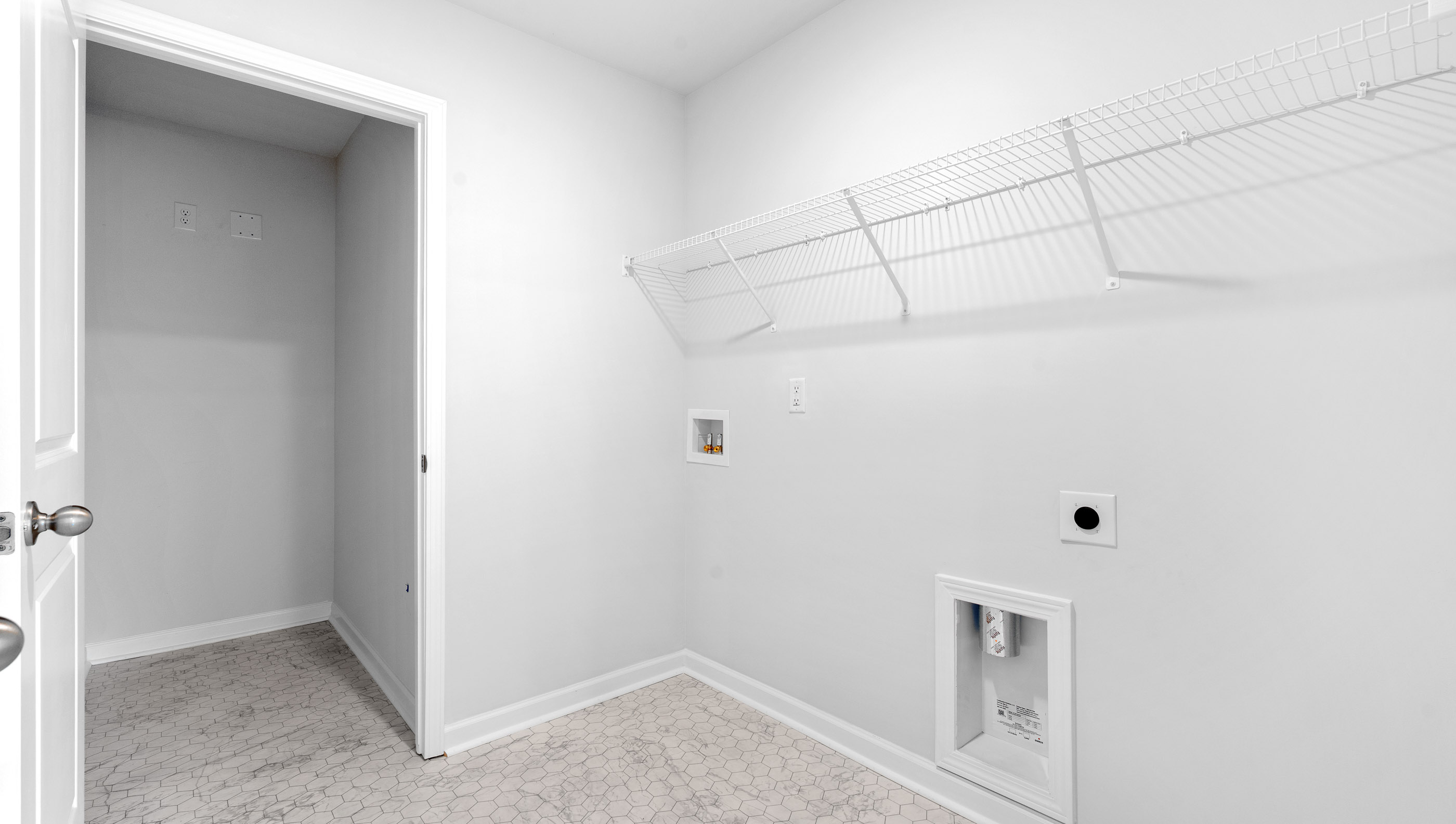 Laundry room with hanging storage racks.