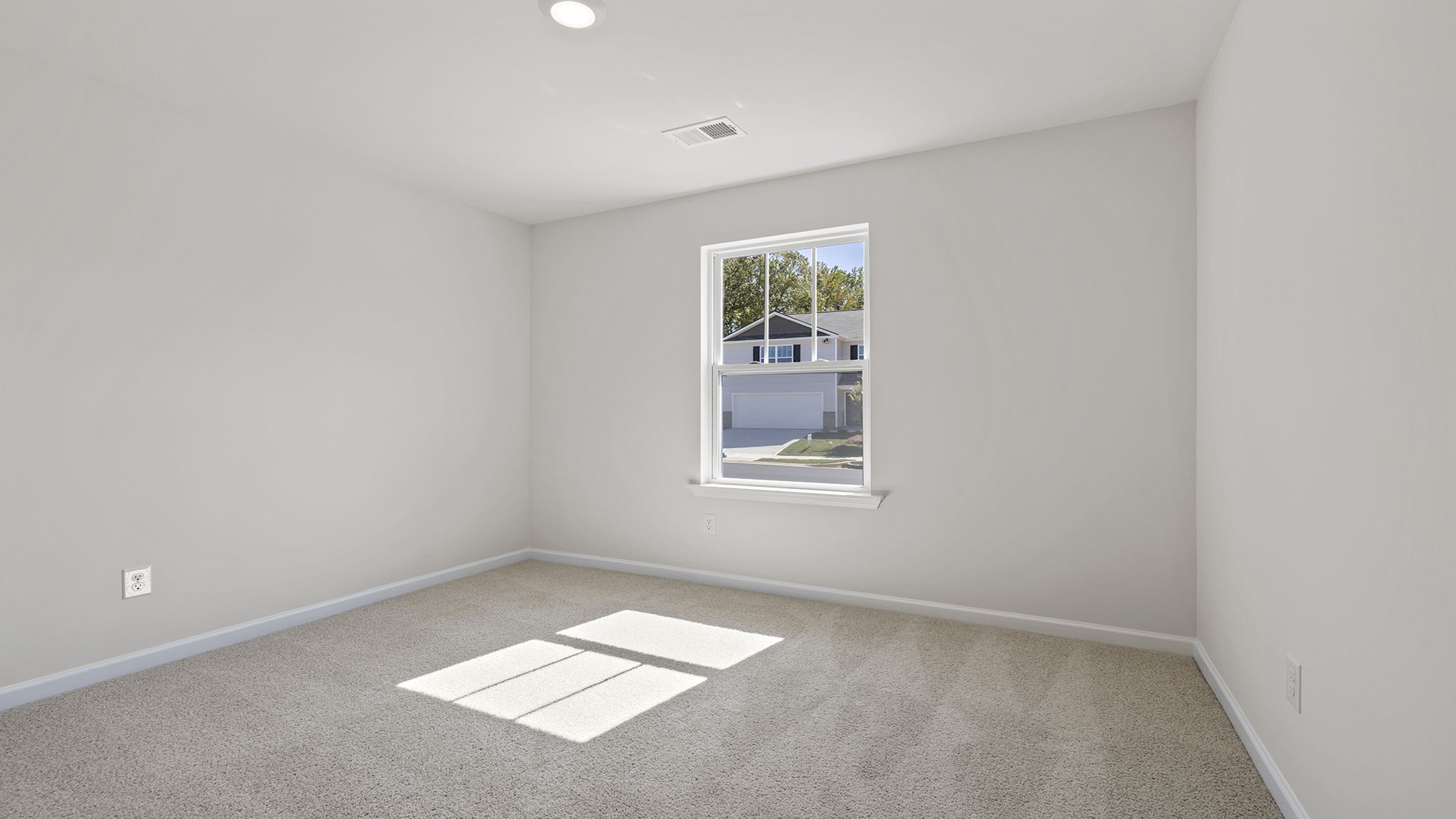 Bedroom with carpet and window.