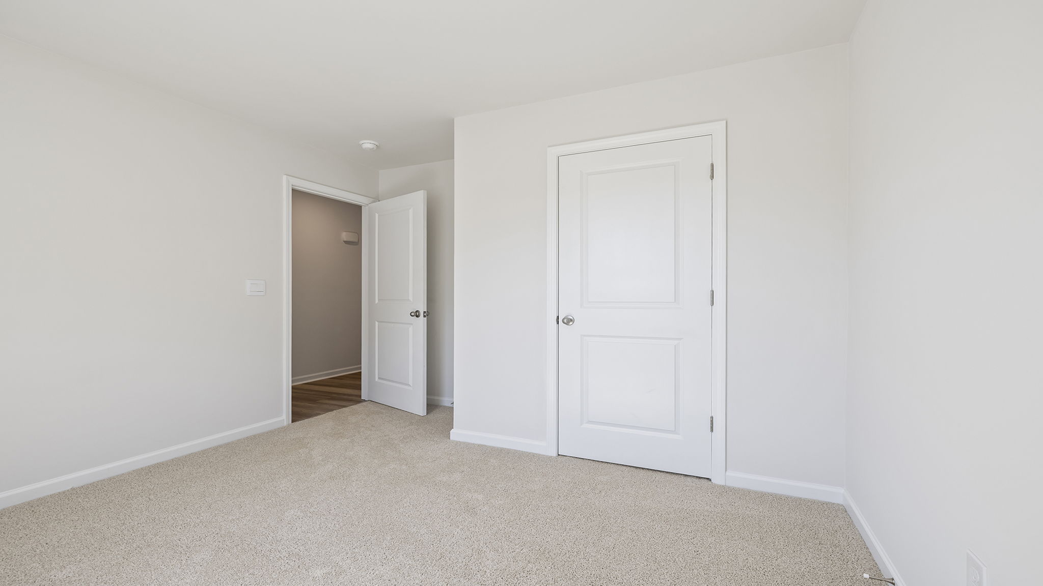 Bedroom with carpet and window.