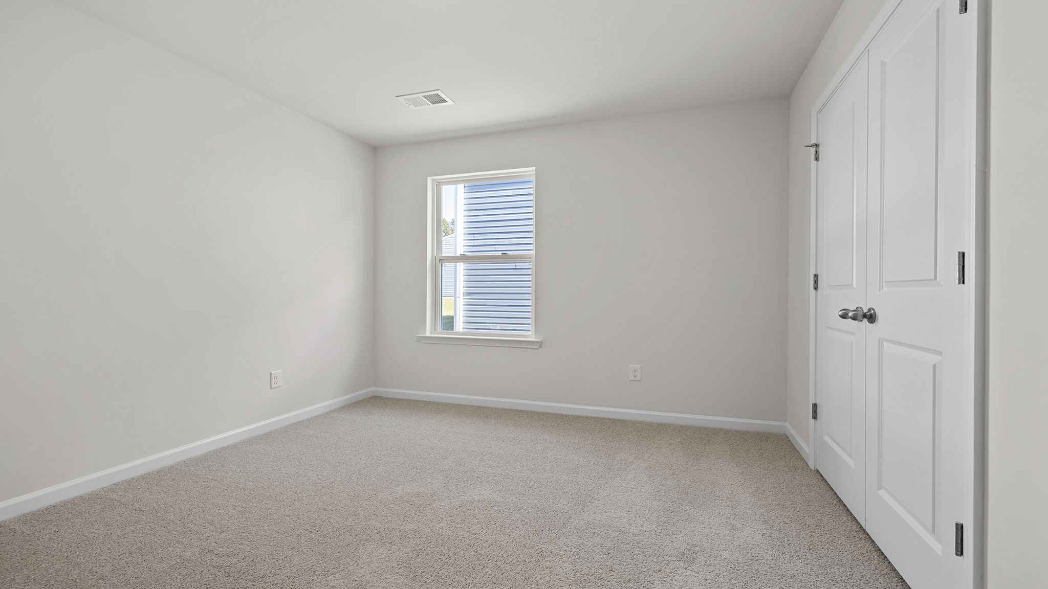 Bedroom with carpet and window.