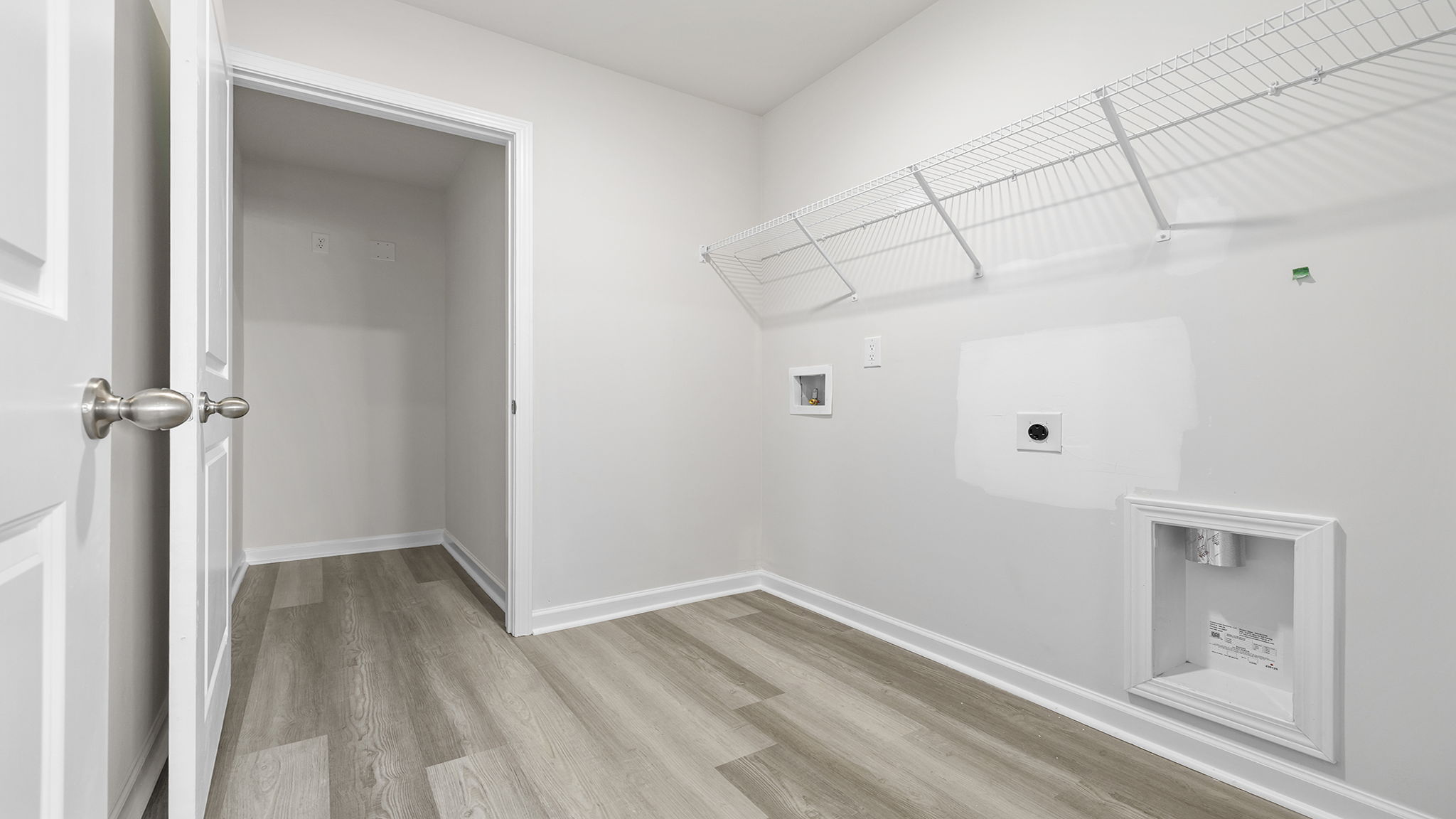Laundry room with hanging storage racks.
