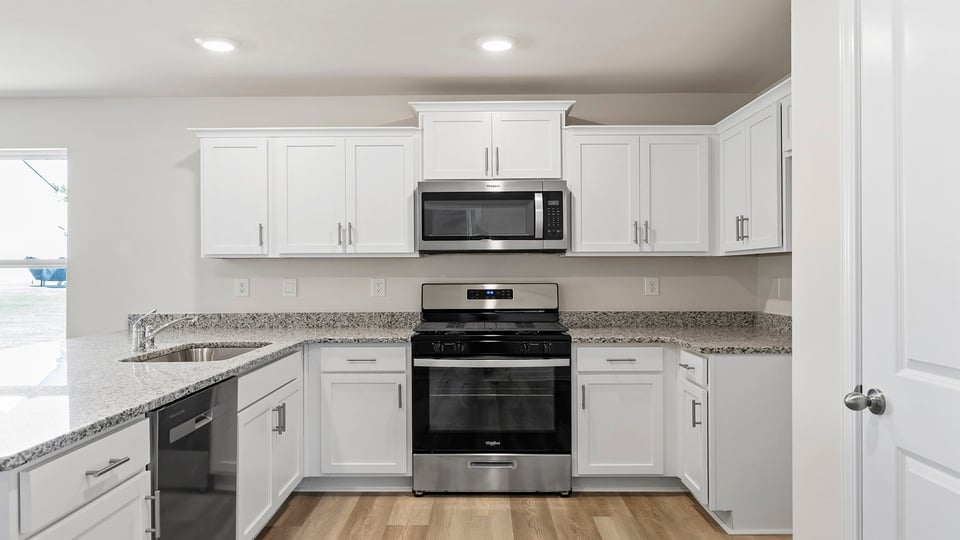 Kitchen with granite countertops and stainless steel appliances.