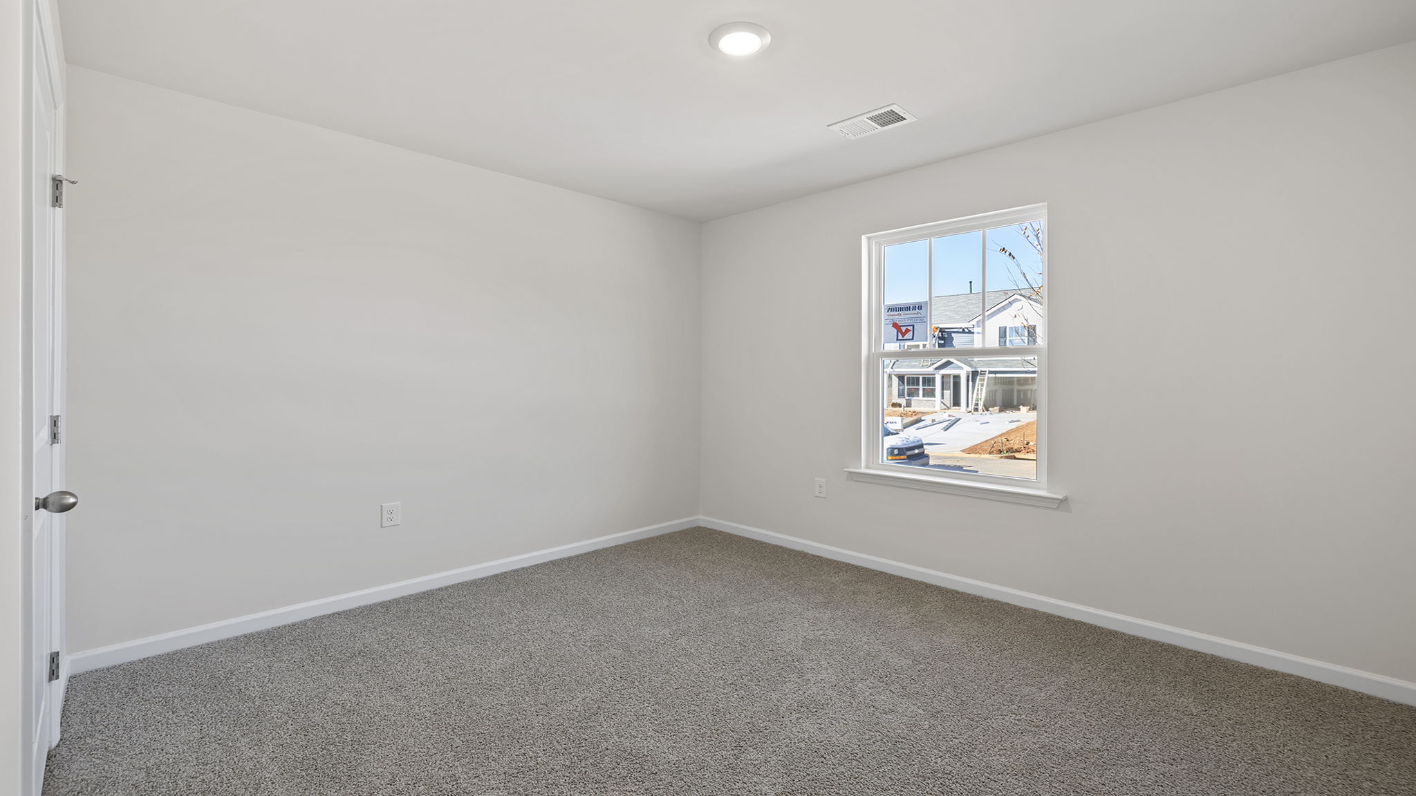 Bedroom with carpet and window.