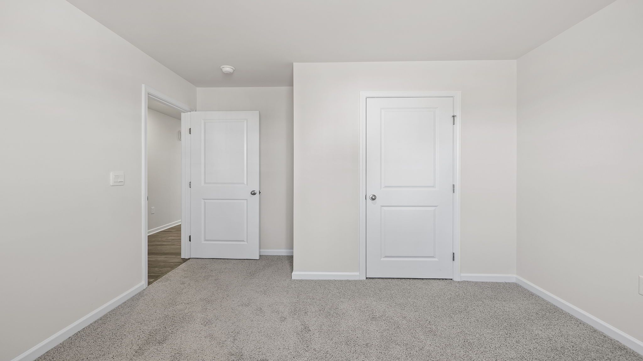 Bedroom with carpet and window.