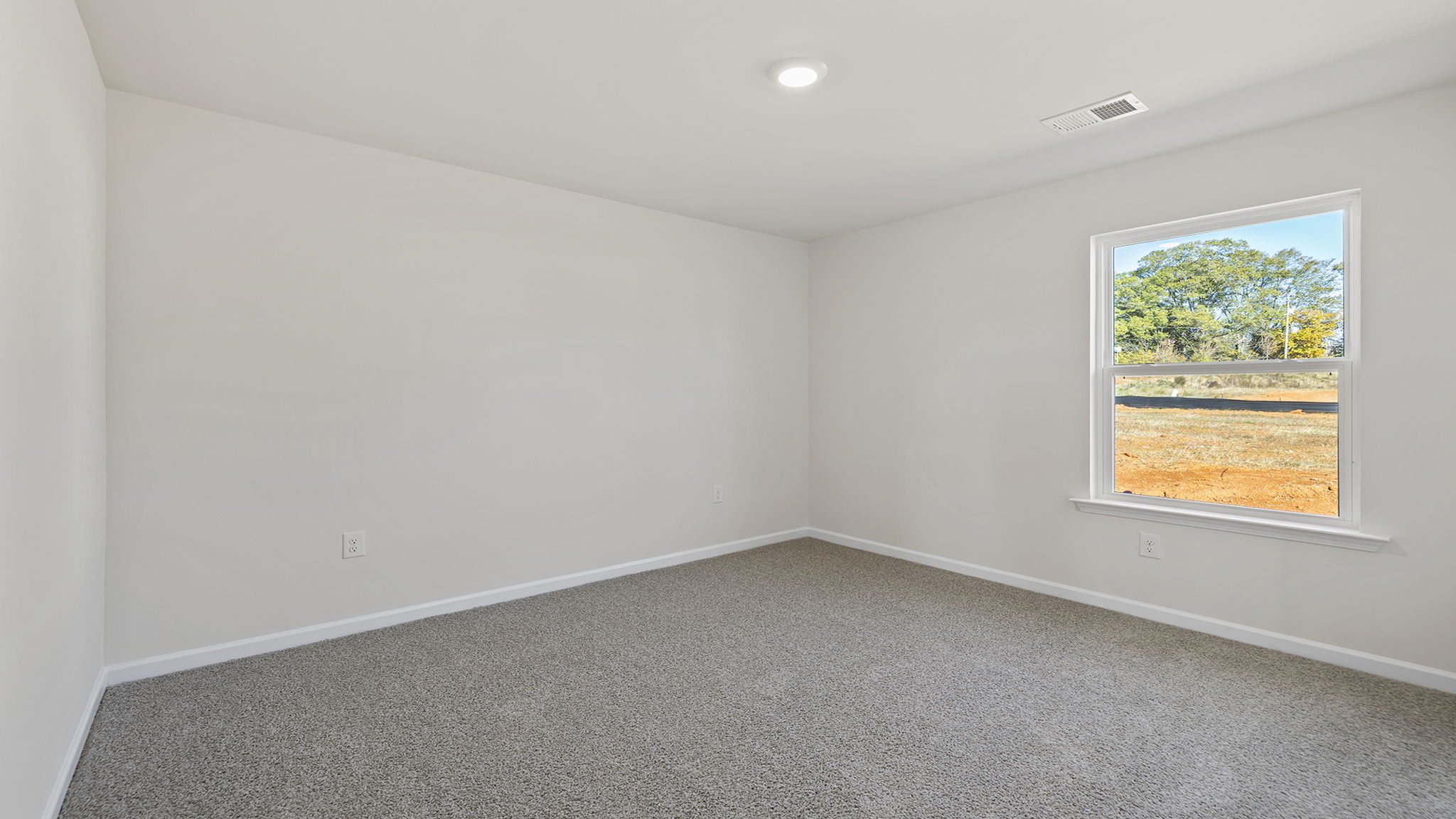 Bedroom with carpet and window.