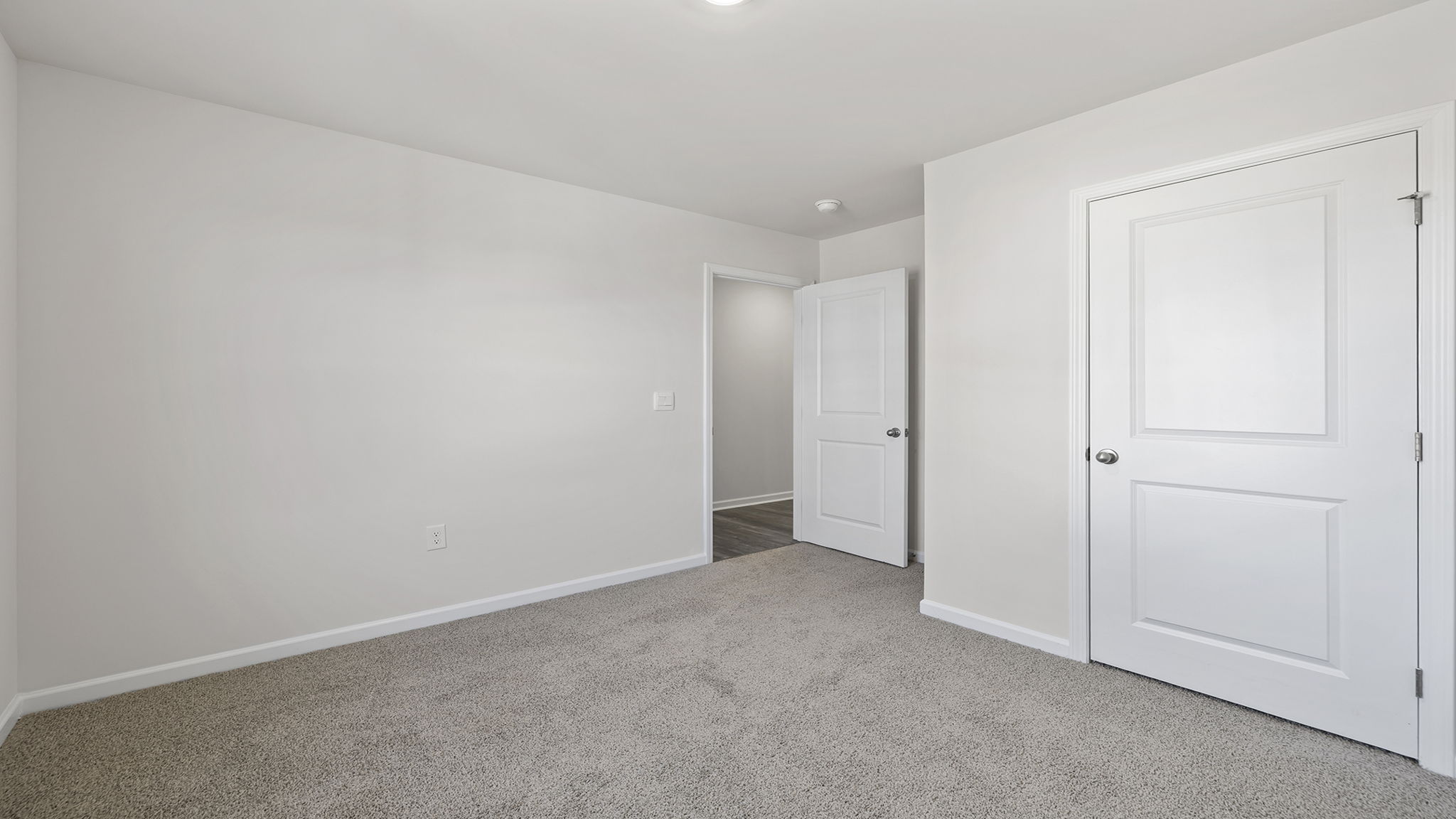Bedroom with carpet and window.