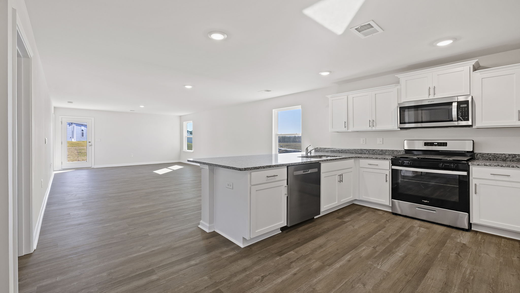 Kitchen with quartz countertops and stainless steel appliances.