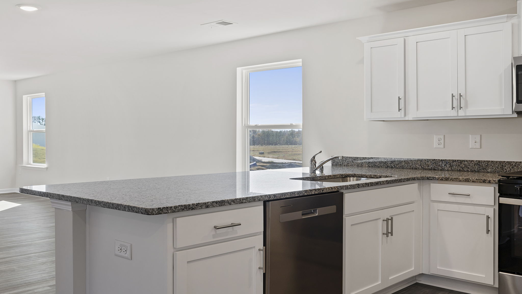 Kitchen with quartz countertops and stainless steel appliances.