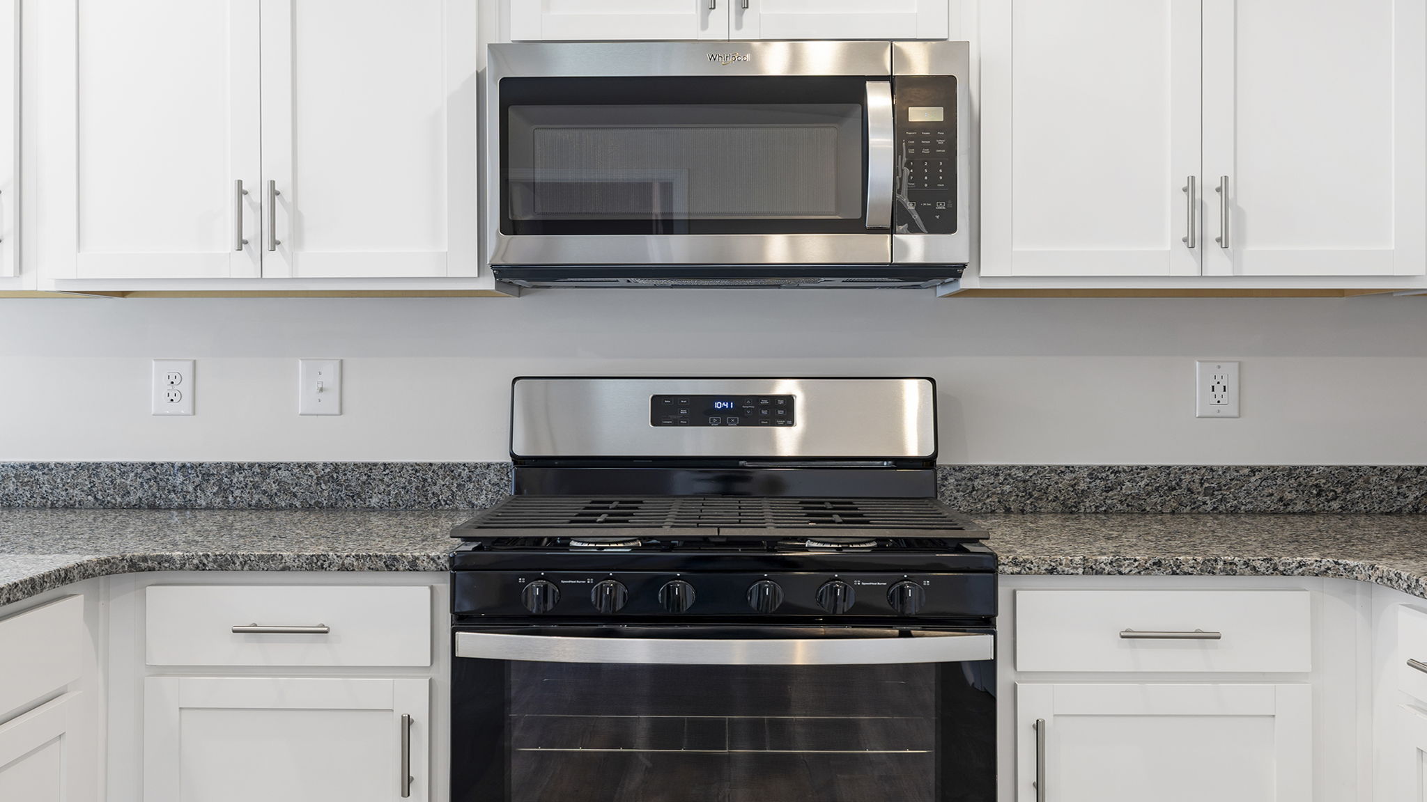 Kitchen with quartz countertops and stainless steel appliances.