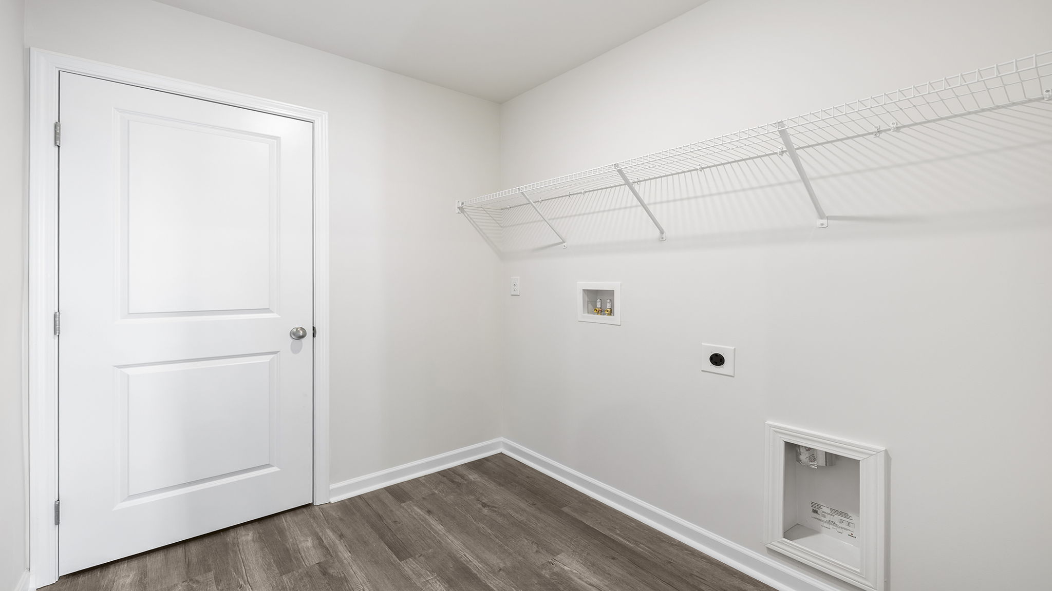 Laundry room with hanging storage racks.