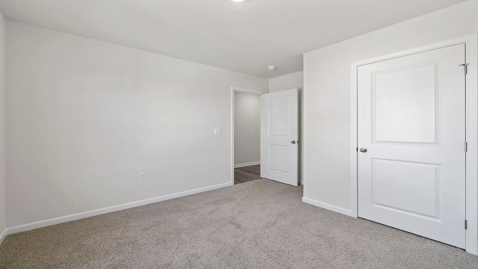Bedroom with carpet and window.