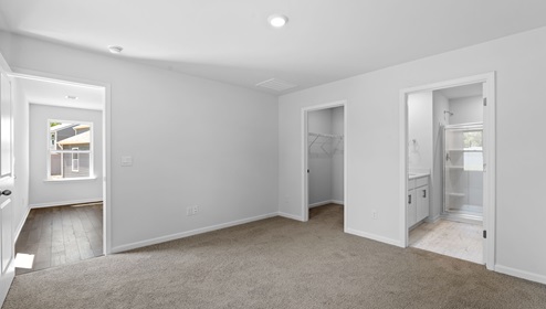 Bedroom with carpet and window.