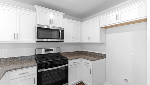 Kitchen and island with granite counter tops.