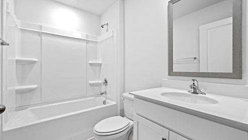 Bathroom with tub and mirror,