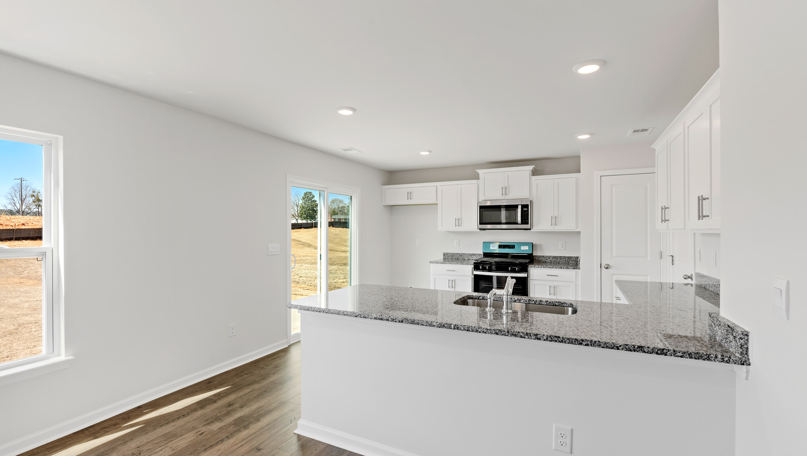 Kitchen with granit countertops and windows.