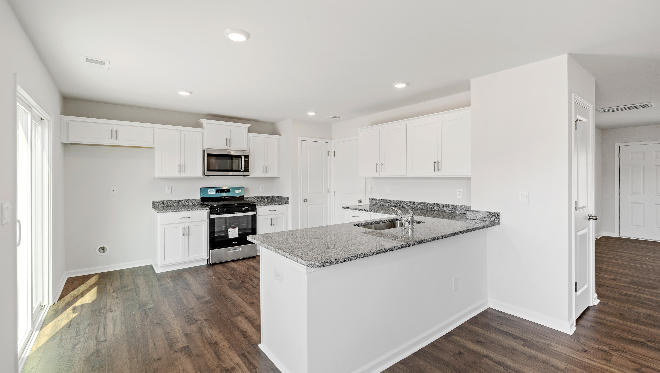 Kitchen with granite countertops and stainless steel appliances.