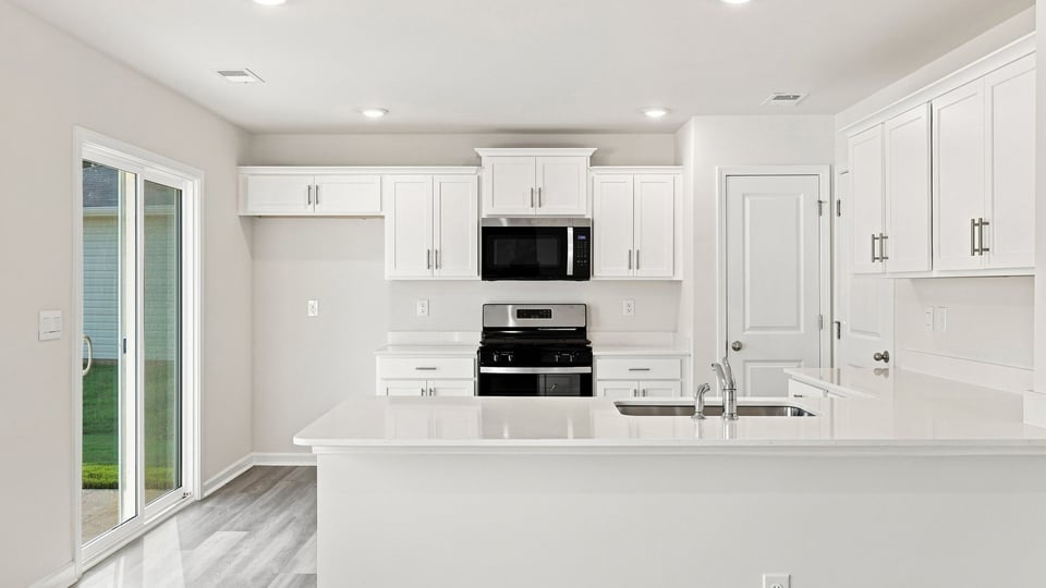 Kitchen with island and cabinets.