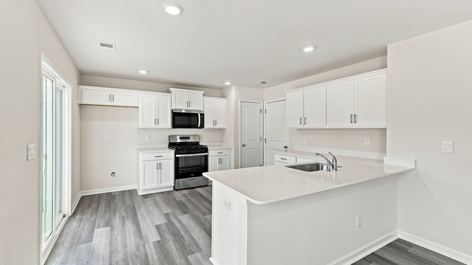 Kitchen with island and cabinets.