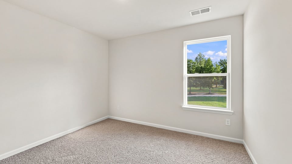 Bedroom with carpet and window.