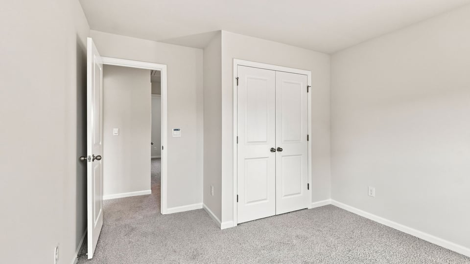 Bedroom with carpet and window.