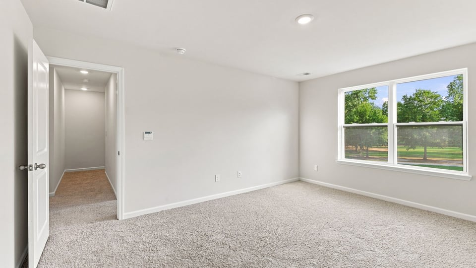 Bedroom with carpet and window.