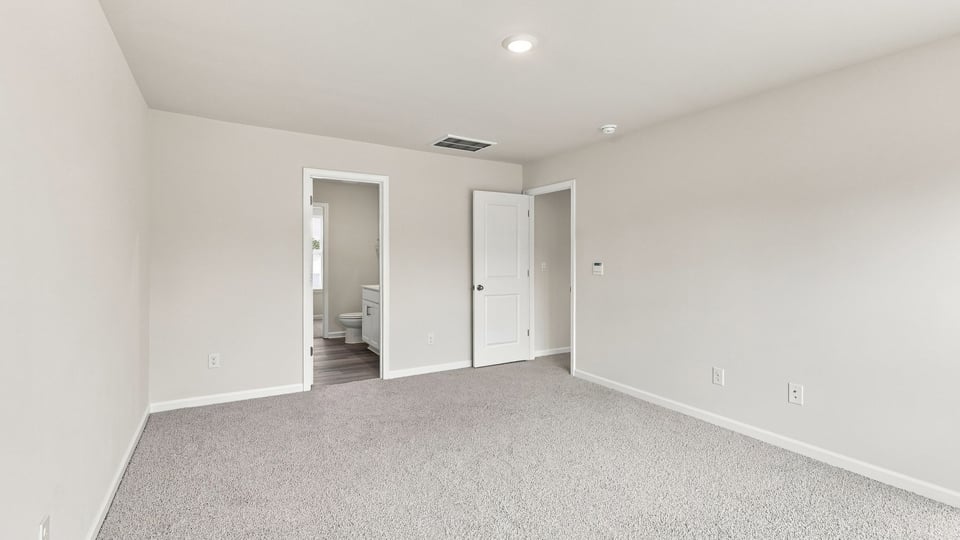 Bedroom with carpet and window.