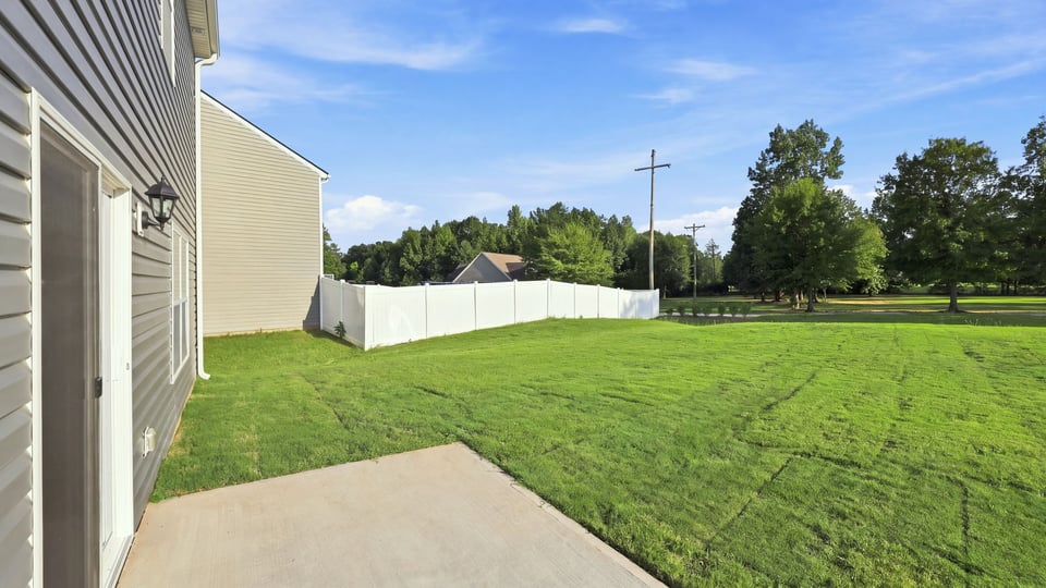 Back exterior with large backyard.