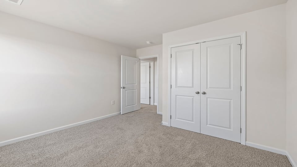 Bedroom with carpet and window.