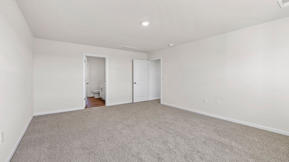 Bedroom with carpet and window.