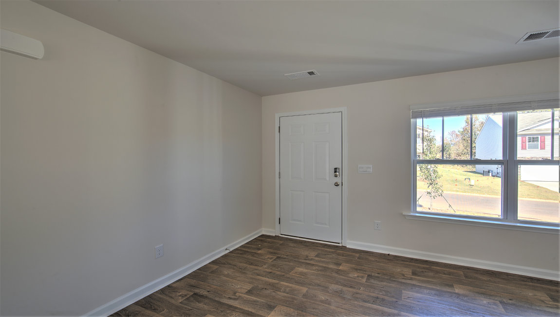 Welcoming foyer with vinyl flooring and large window