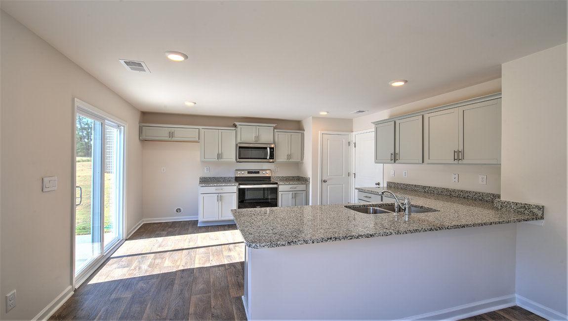 Kitchen with white cabinets, granite countertops and stainless steel appliances