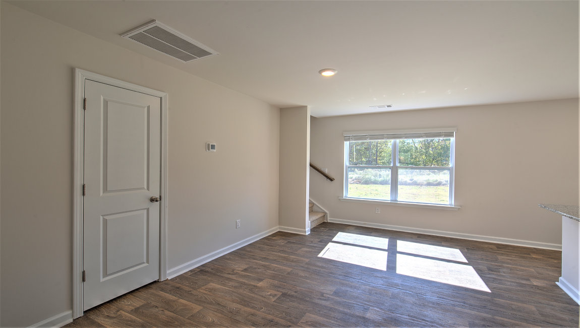 Open dining room beside kitchen with large window