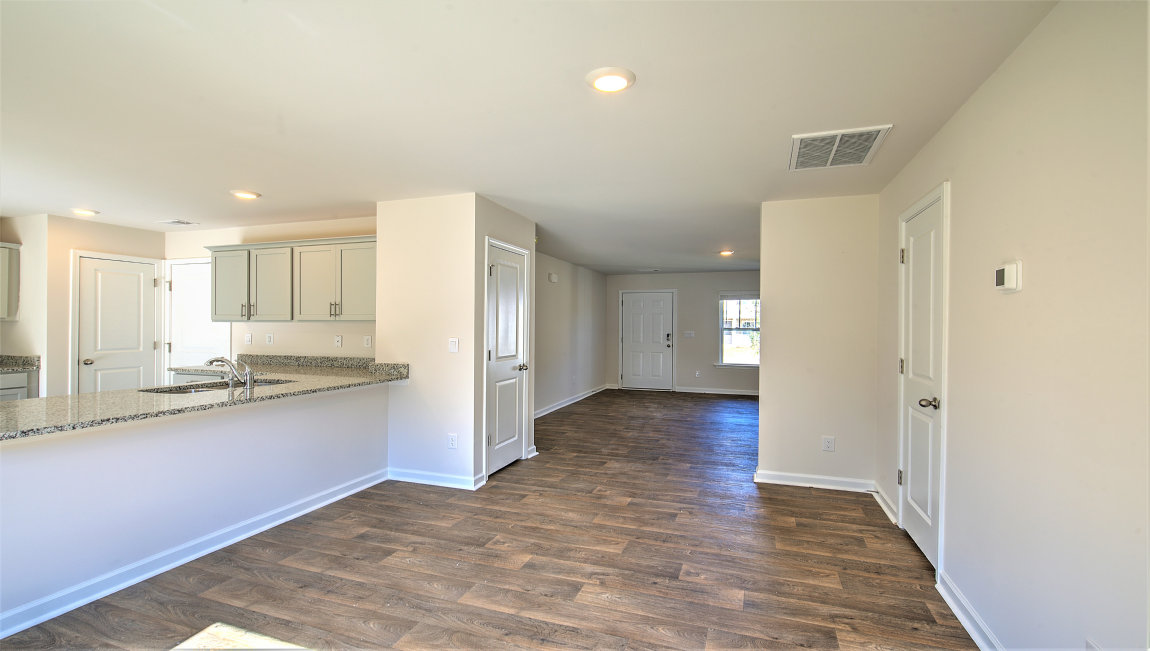 Open dining room beside kitchen with large window