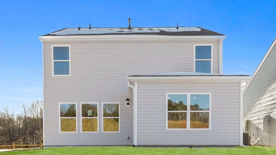 Exterior of home with large backyard.