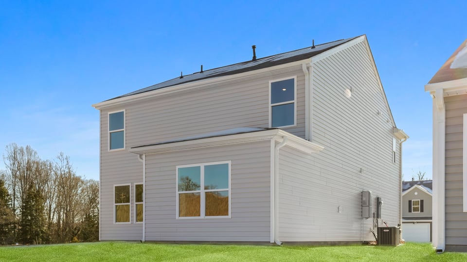 Exterior of home with large backyard.