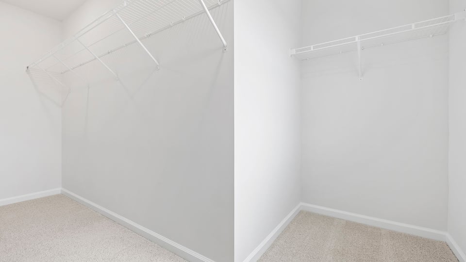 Walk in closet with shelves.