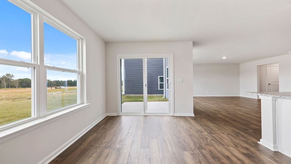 Breakfast area with windows and sliding doors.