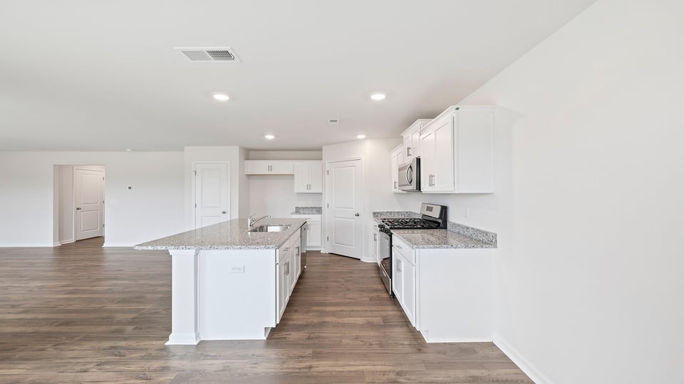Kitchen with island and granite countertops.