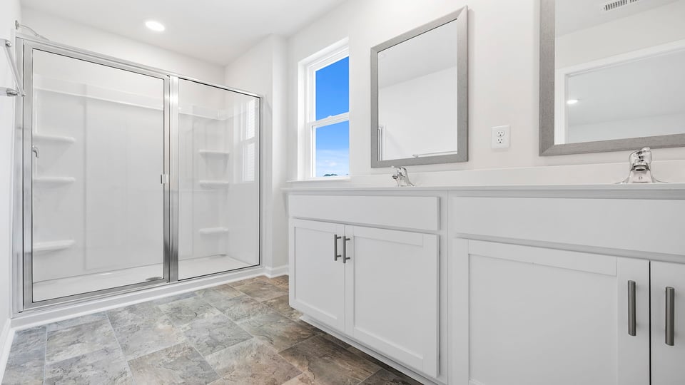 Bathroom with vanity and walk in shower.