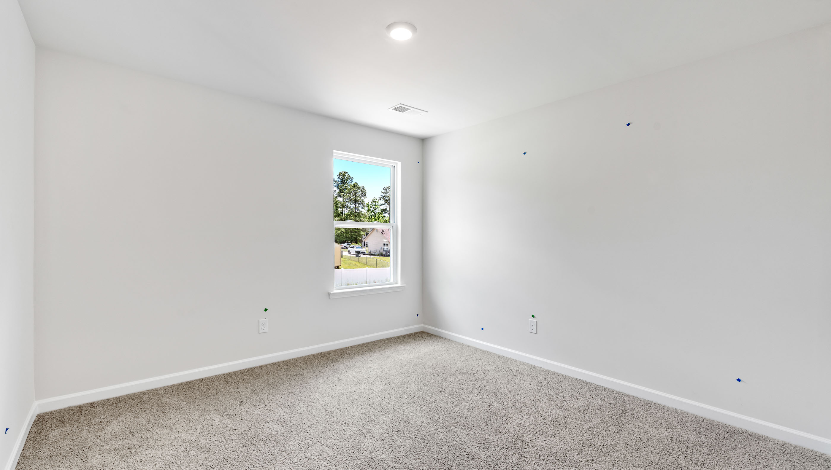 Bedroom with carpet and window.