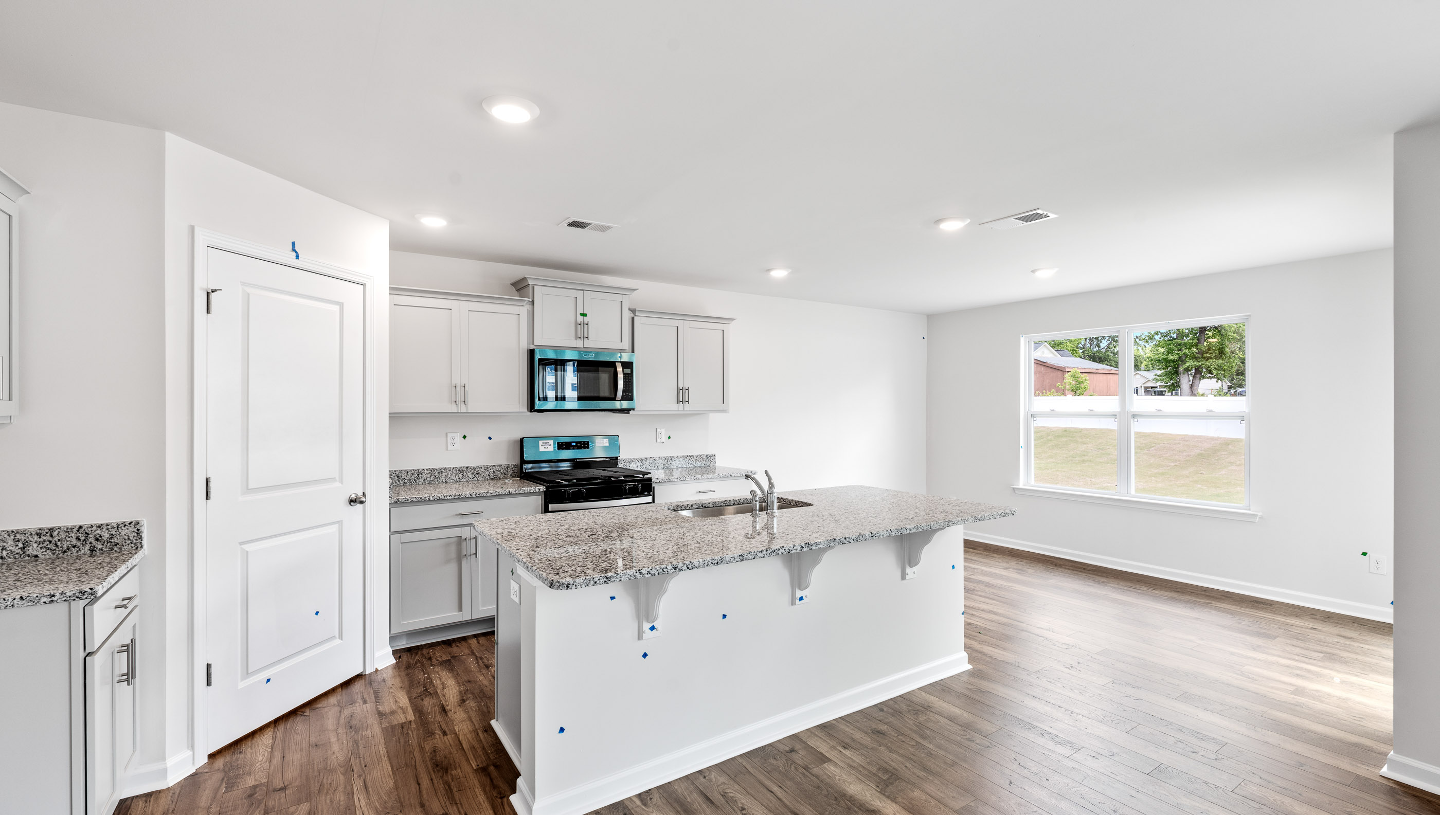 Kitchen and island with granite counter tops.